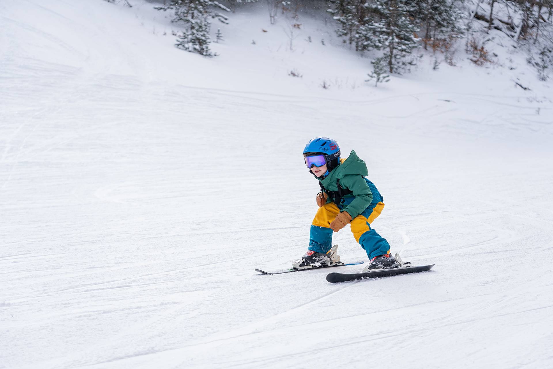 Little boy ripping down the ski hill