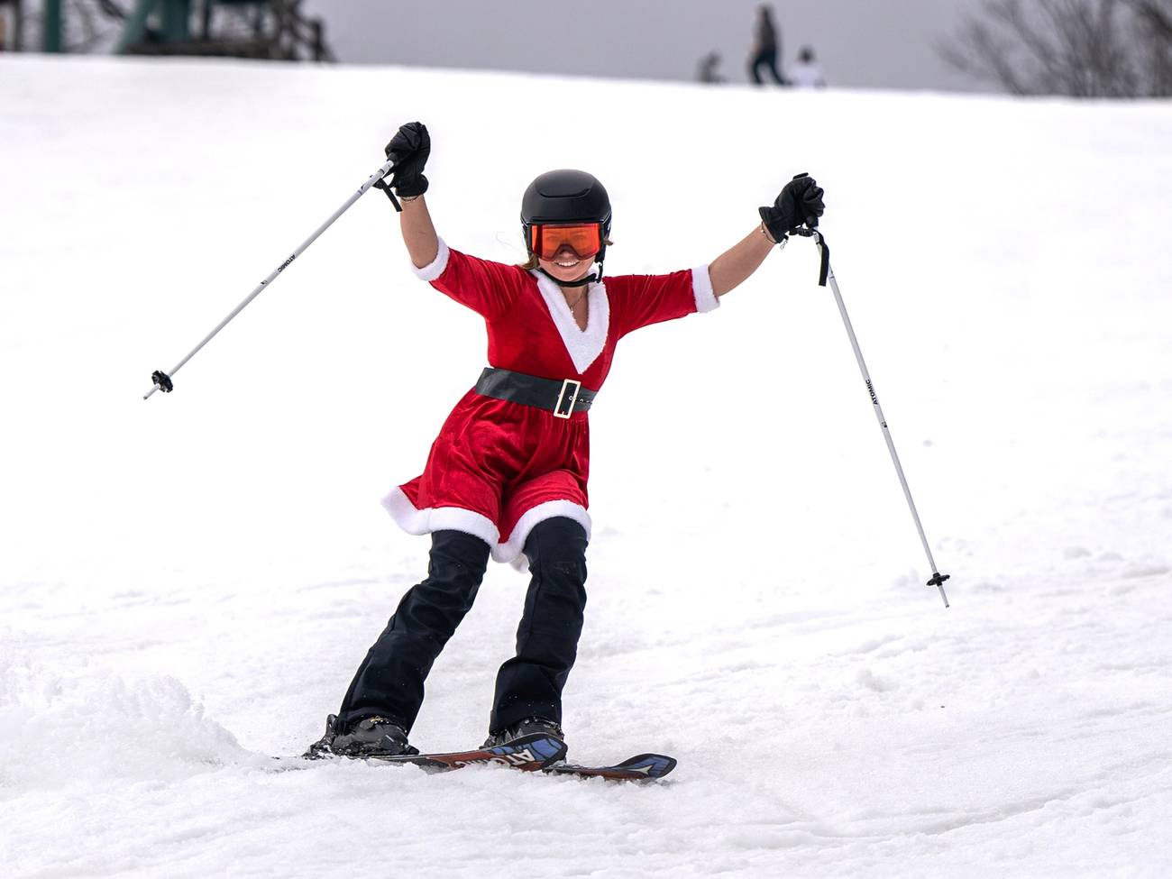Lady with santa costume skiing down Hemlock