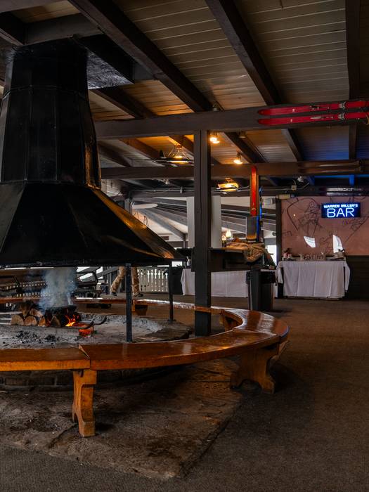 A freshly lit fire in the fireplace inside the Eagles Nest at Boyne Mountain