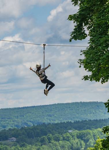 person riding zipline at boyne mountain