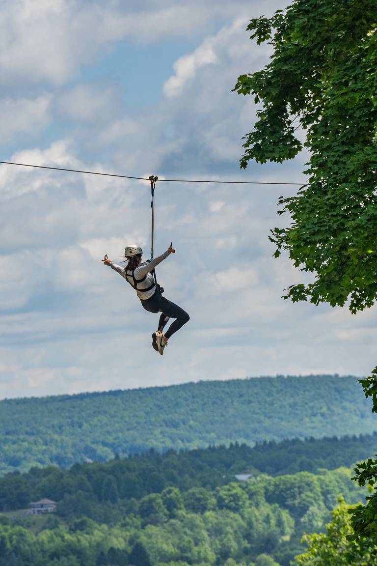 person riding zipline at boyne mountain