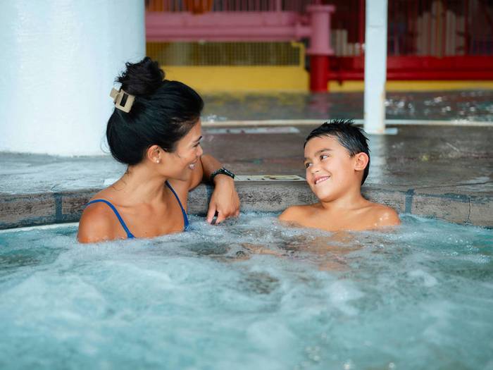 Mother and son looking at each other and smiling while at Avalanche Bay Waterpark.