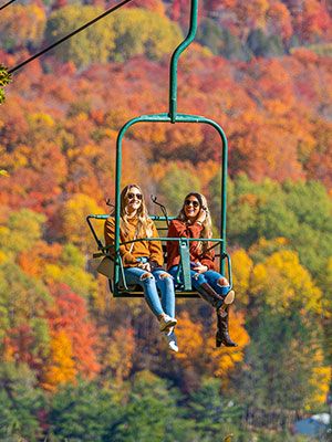 Two ladies on the Hemlock lift in the fall
