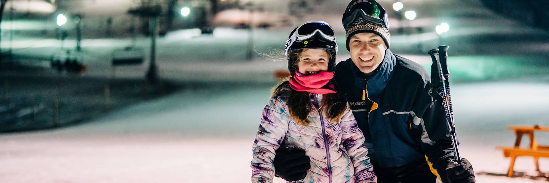 Father and daughter on base of hill