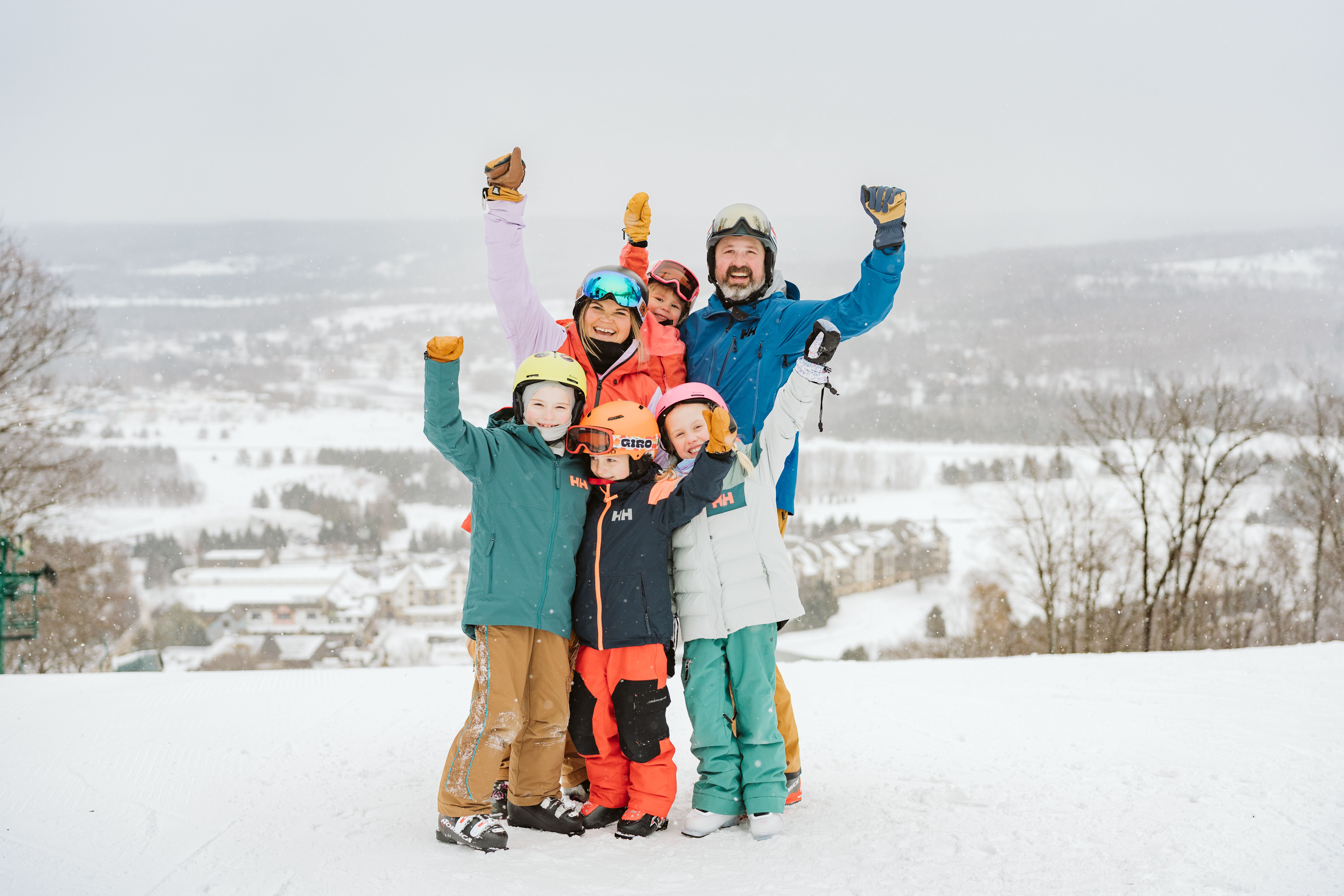 family having fun with arms up in excitement