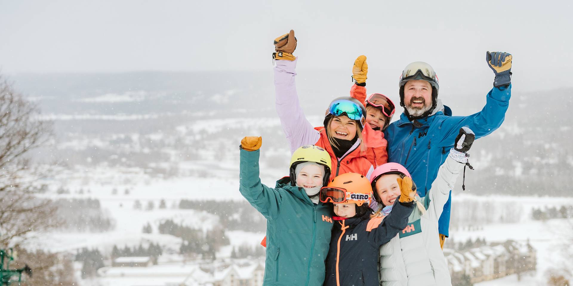 family having fun with arms up in excitement