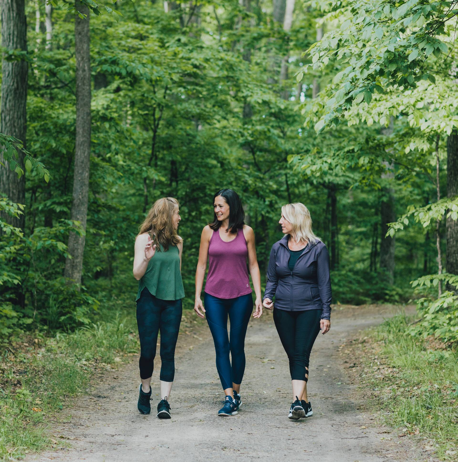 Group of women on a hike in the woods in the summer