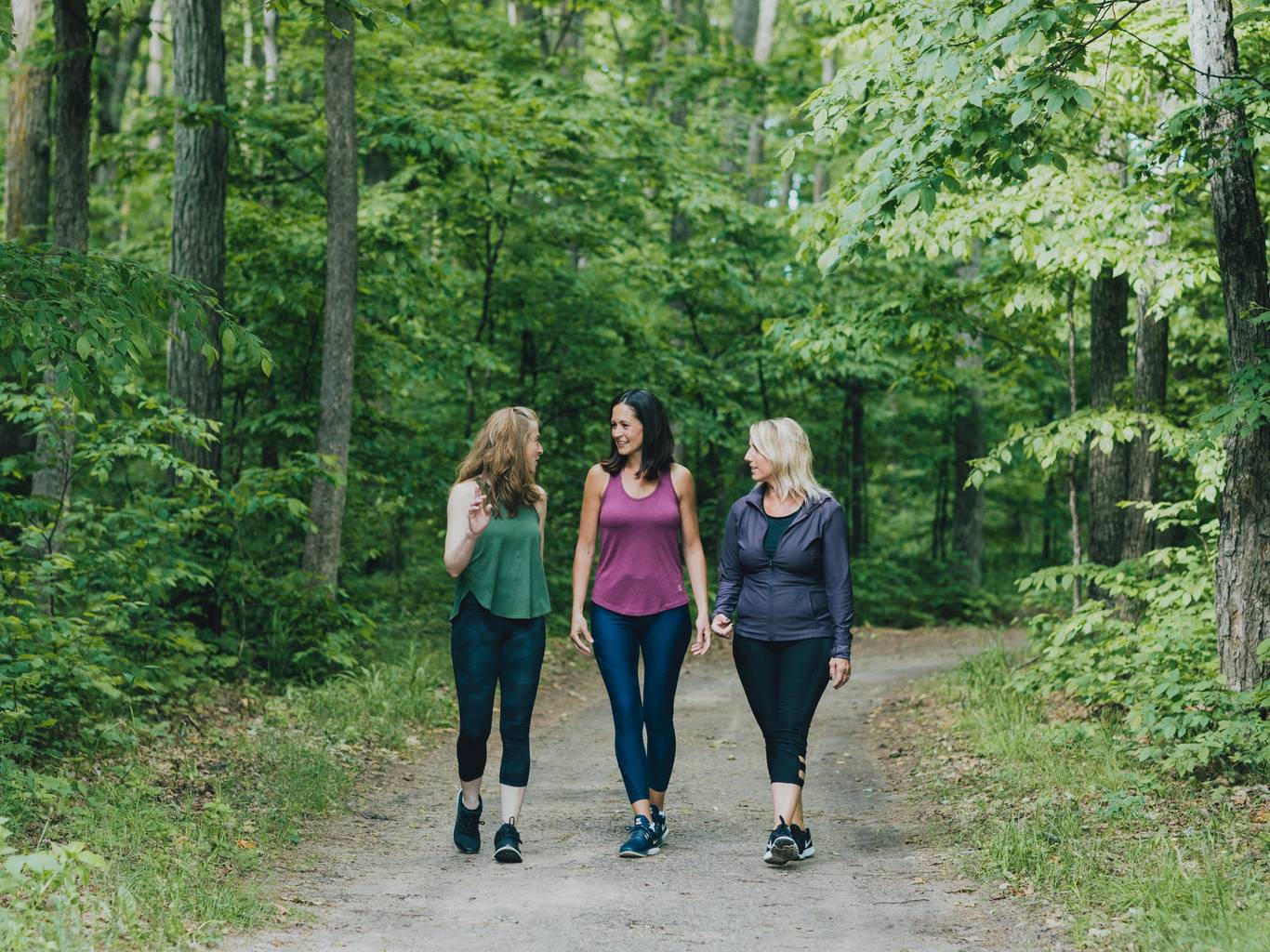 Group of women on a hike in the woods in the summer