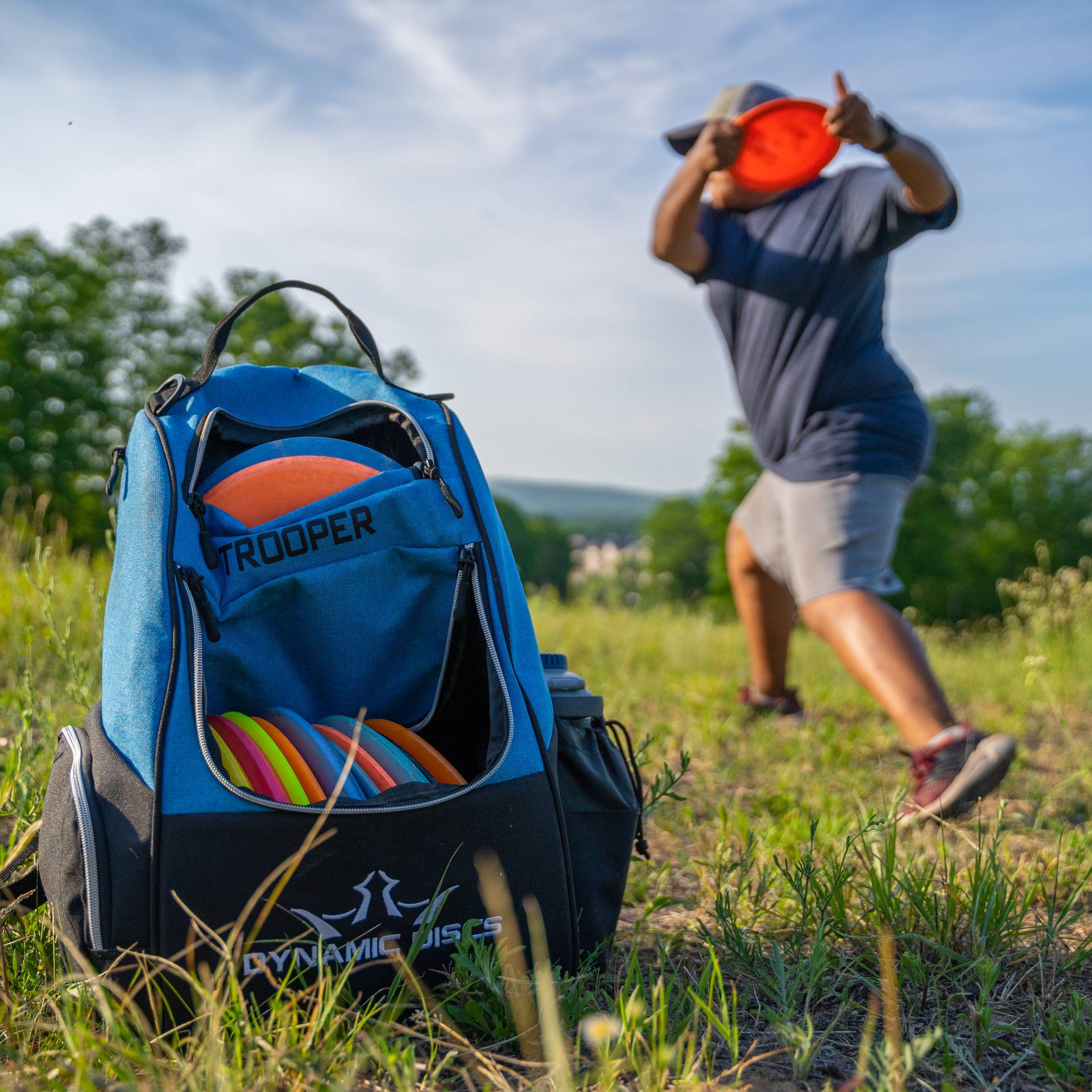Person throwing a disc while disc golfing