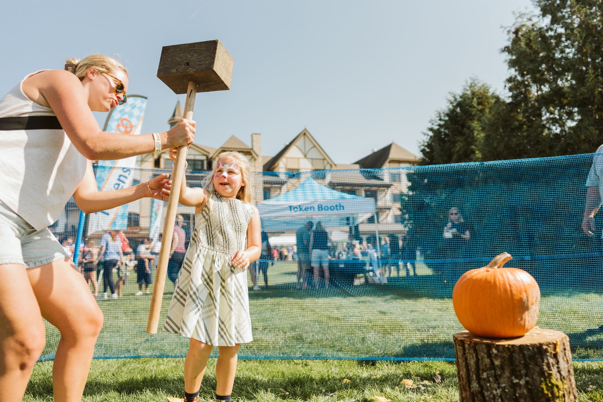 mother and daughter pumpkin smashing