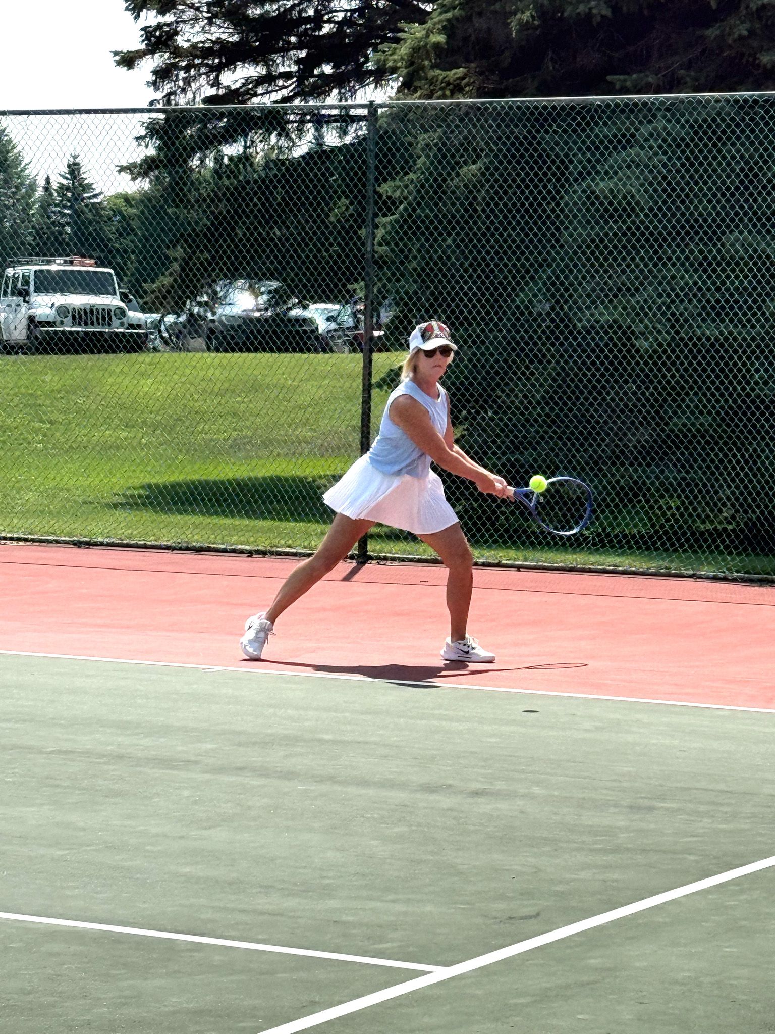 lady about to hit the tennis ball in volley