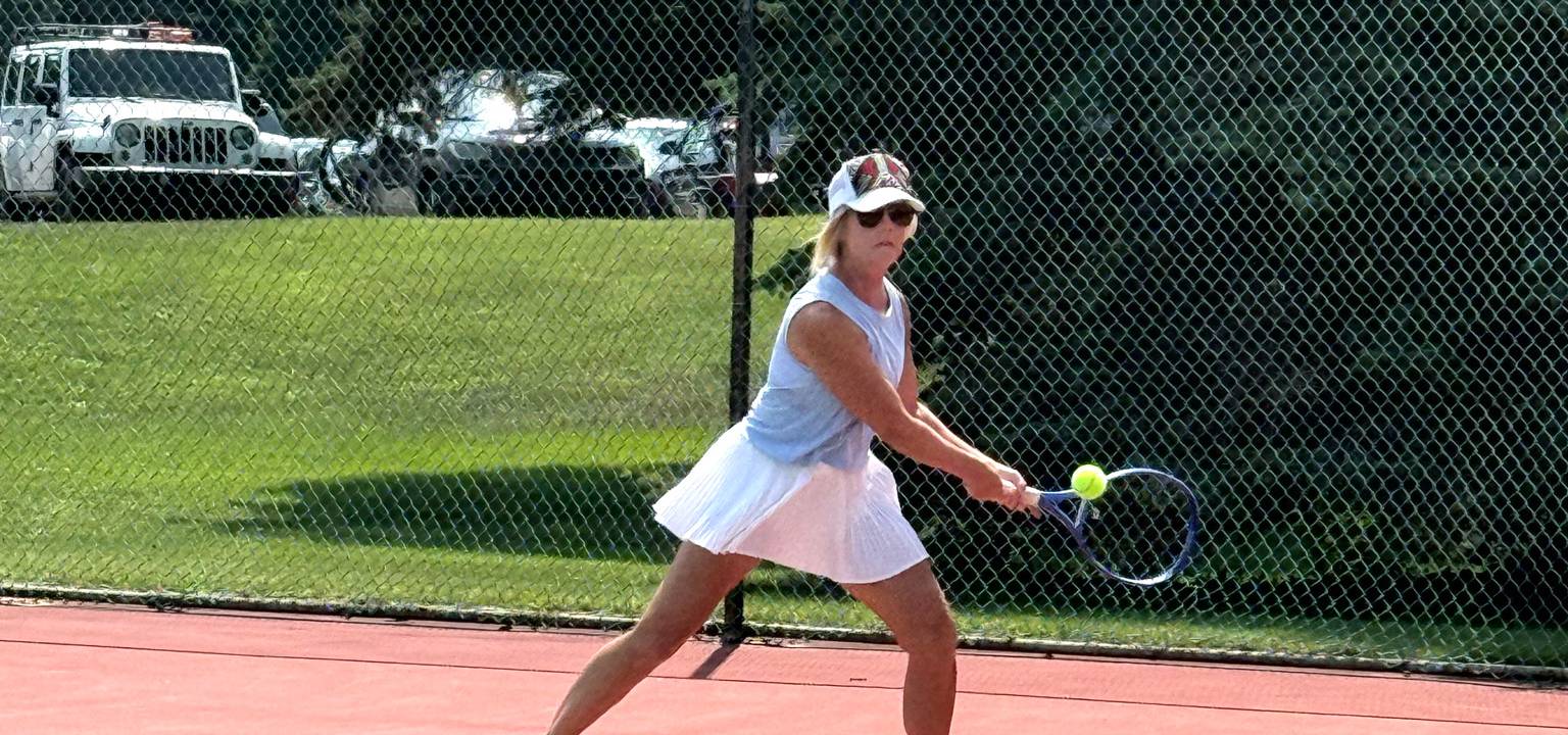 lady about to hit the tennis ball in volley