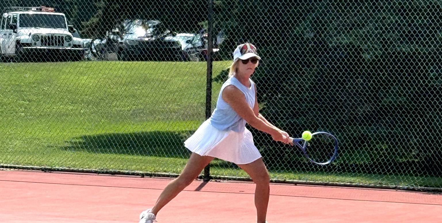 lady about to hit the tennis ball in volley