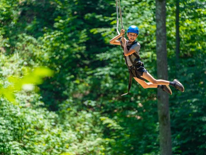Boy ziplining in the summer