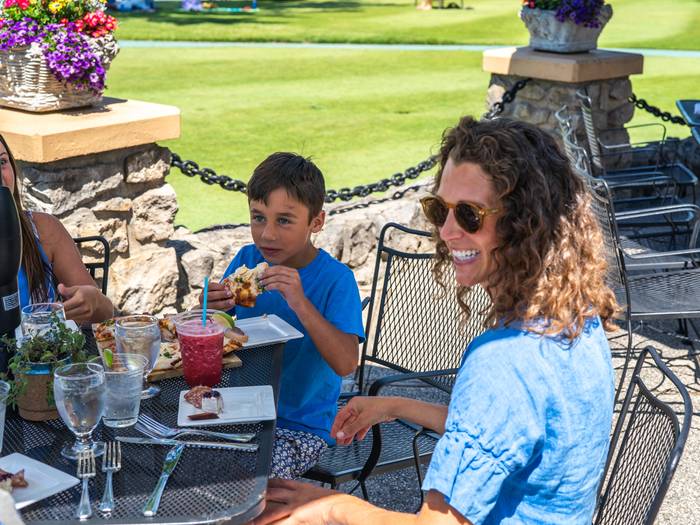 Mom and son enjoying food and drinks at the Beach House