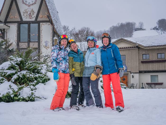 Group of adults in front of clock tower in ski gear