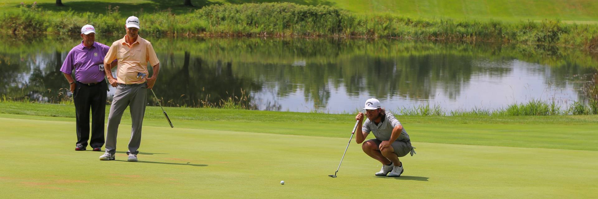 Golfers on the green lining up put