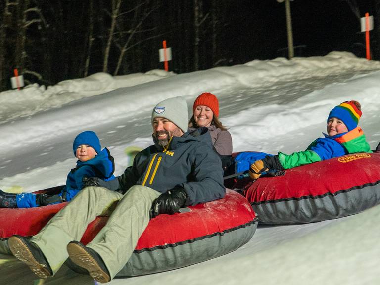 Family tubing at night