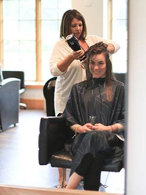 Woman getting hair blowdryed at The Spa