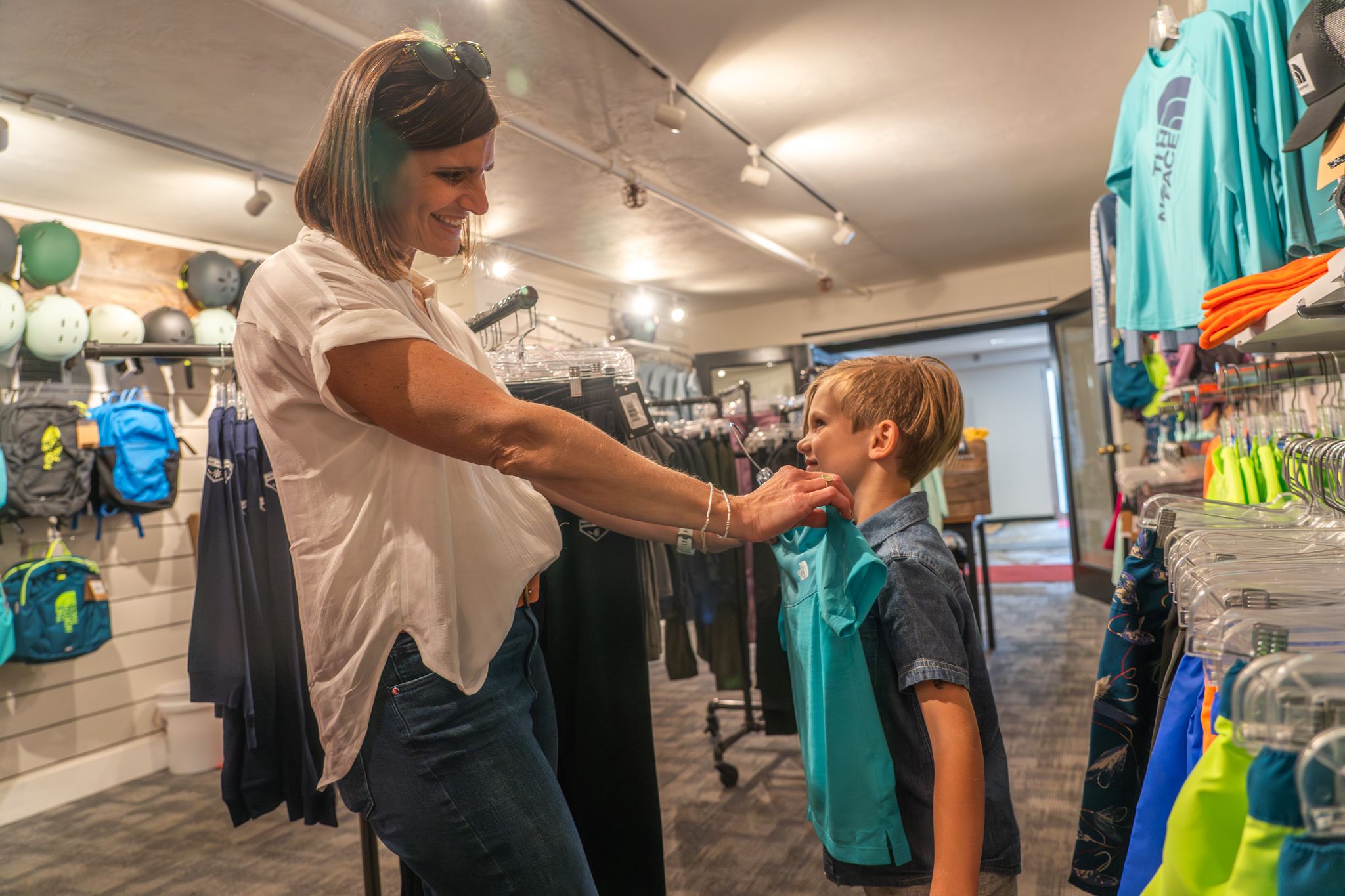 Mom and her boy trying on shirts