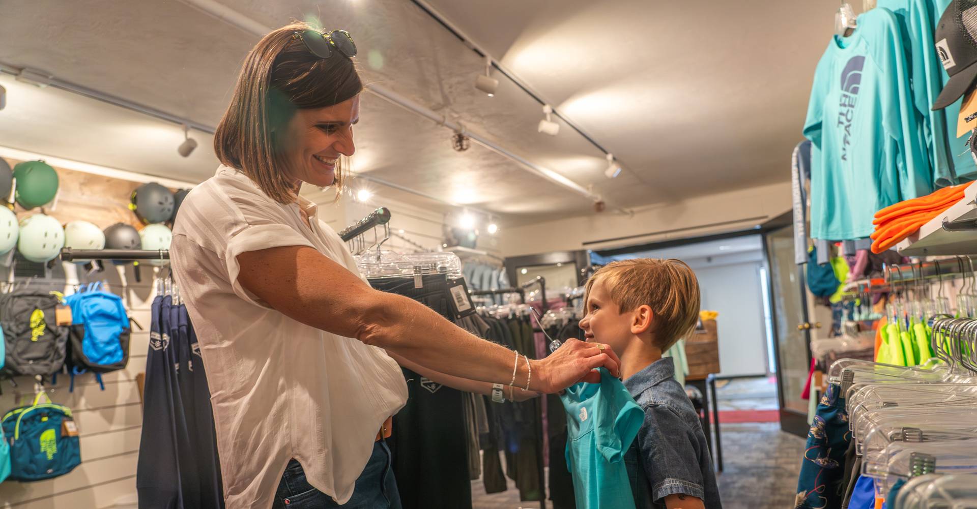 Mom and her boy trying on shirts