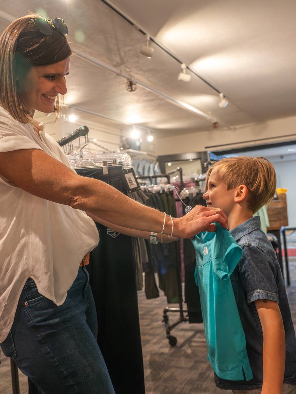 Mom and her boy trying on shirts