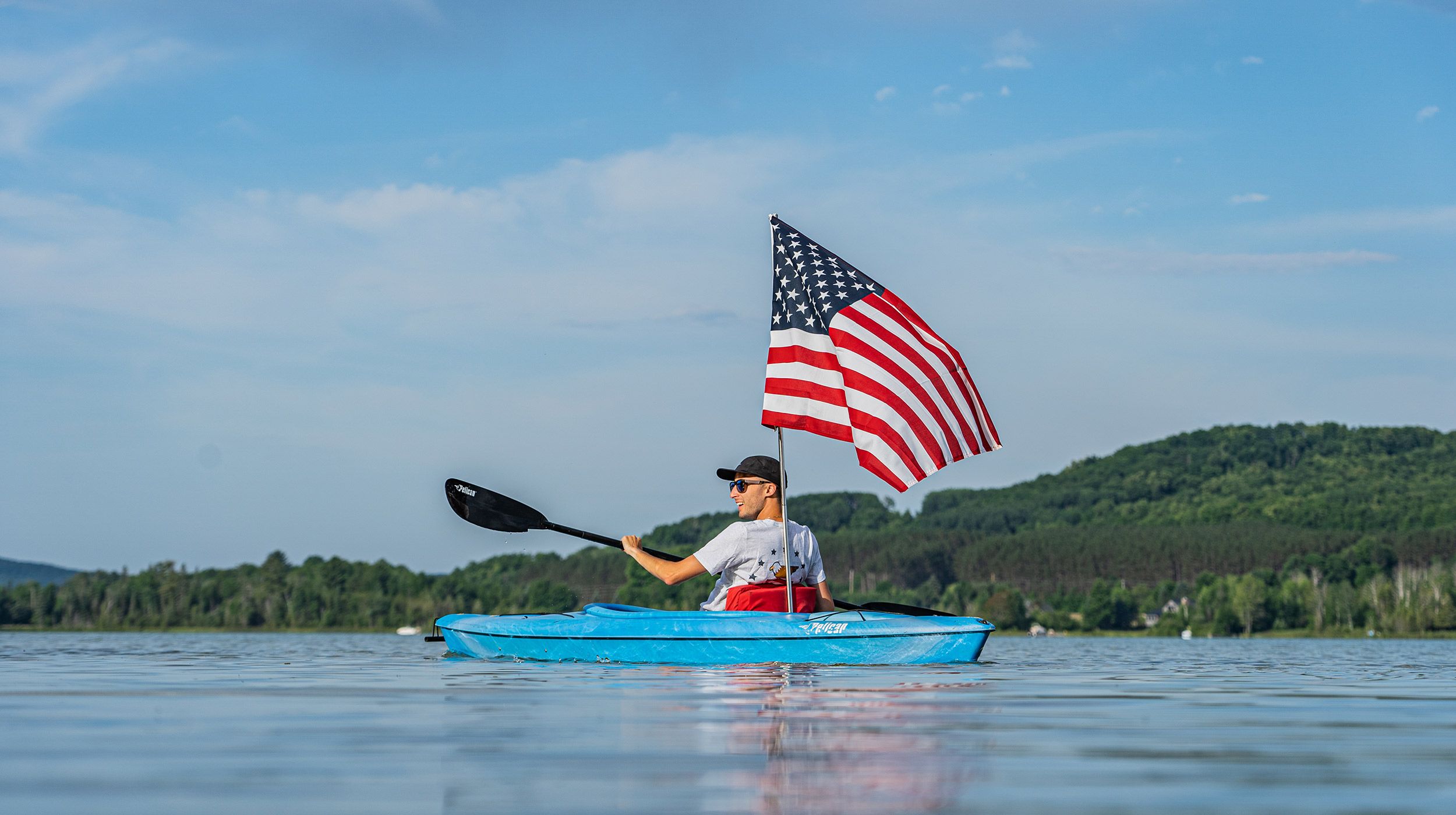 kayaker holding american flag