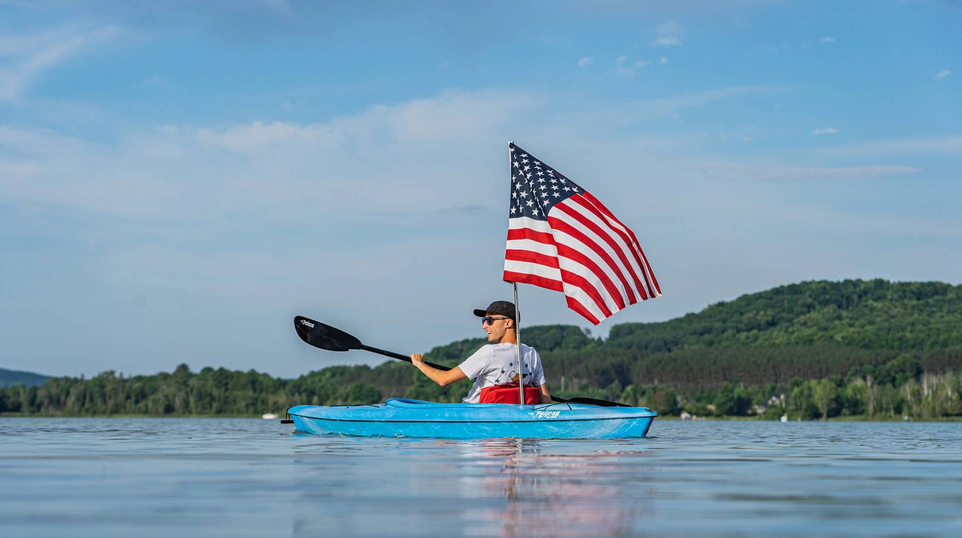 kayaker holding american flag