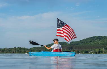 kayaker holding american flag