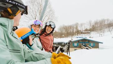 family riding mountain express lift