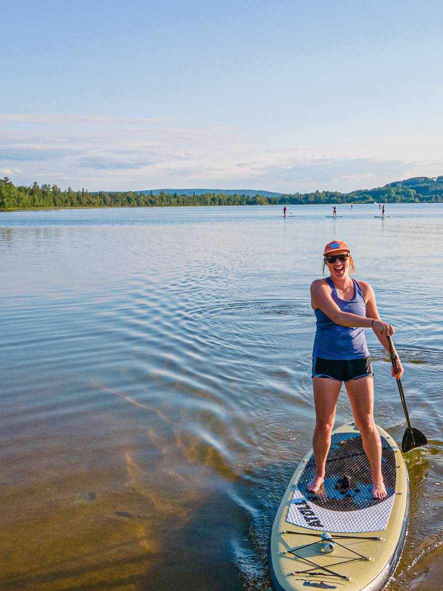 Girl paddleboarding on deer lake