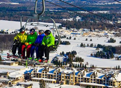 Four men riding up the Meadows chairlift.
