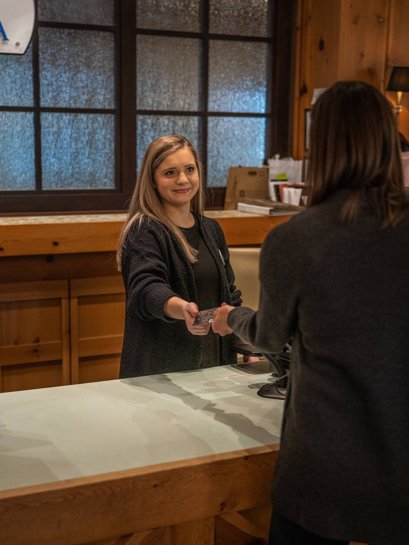woman paying with credit card at The Spa