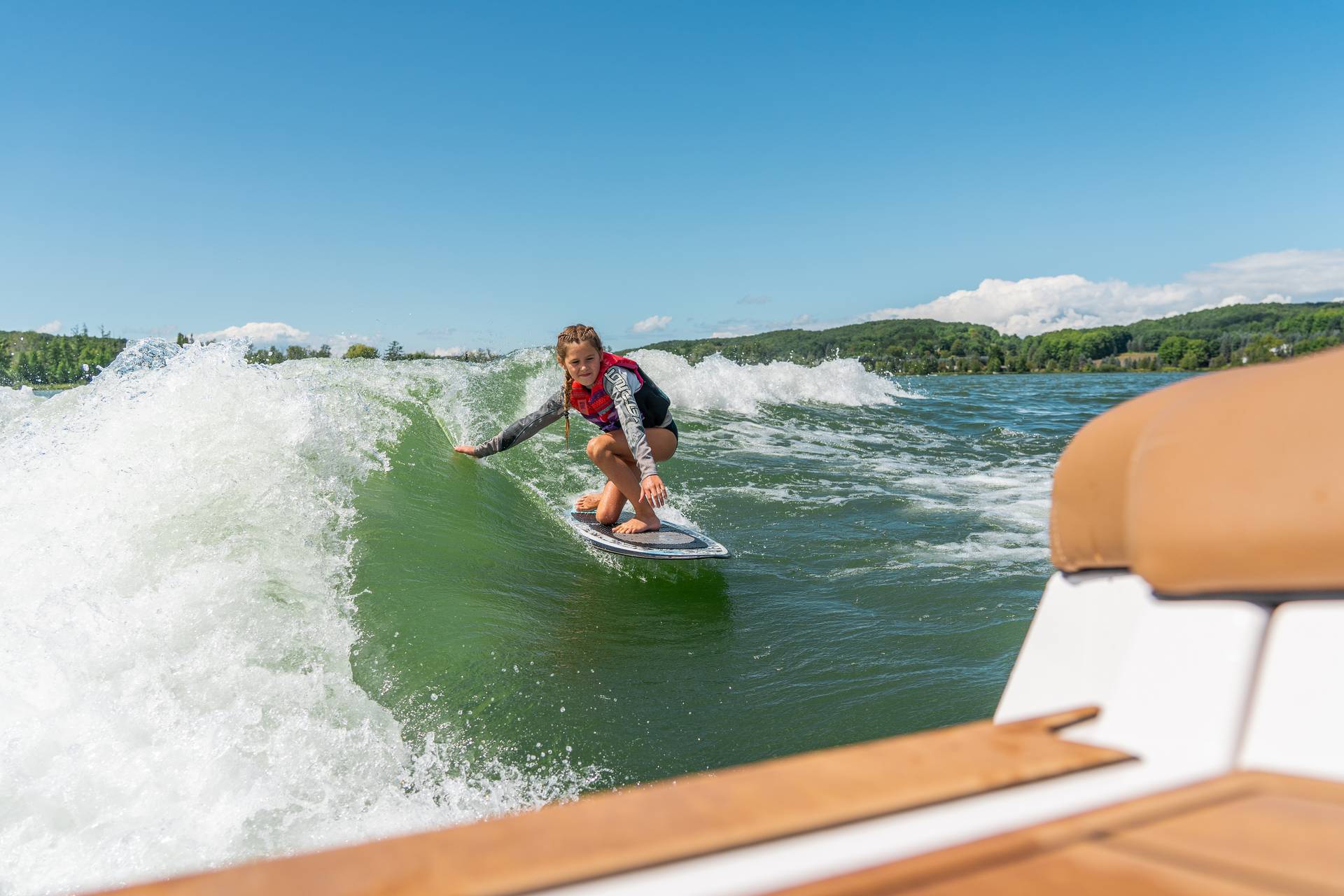girl wakesurfing on deer lake
