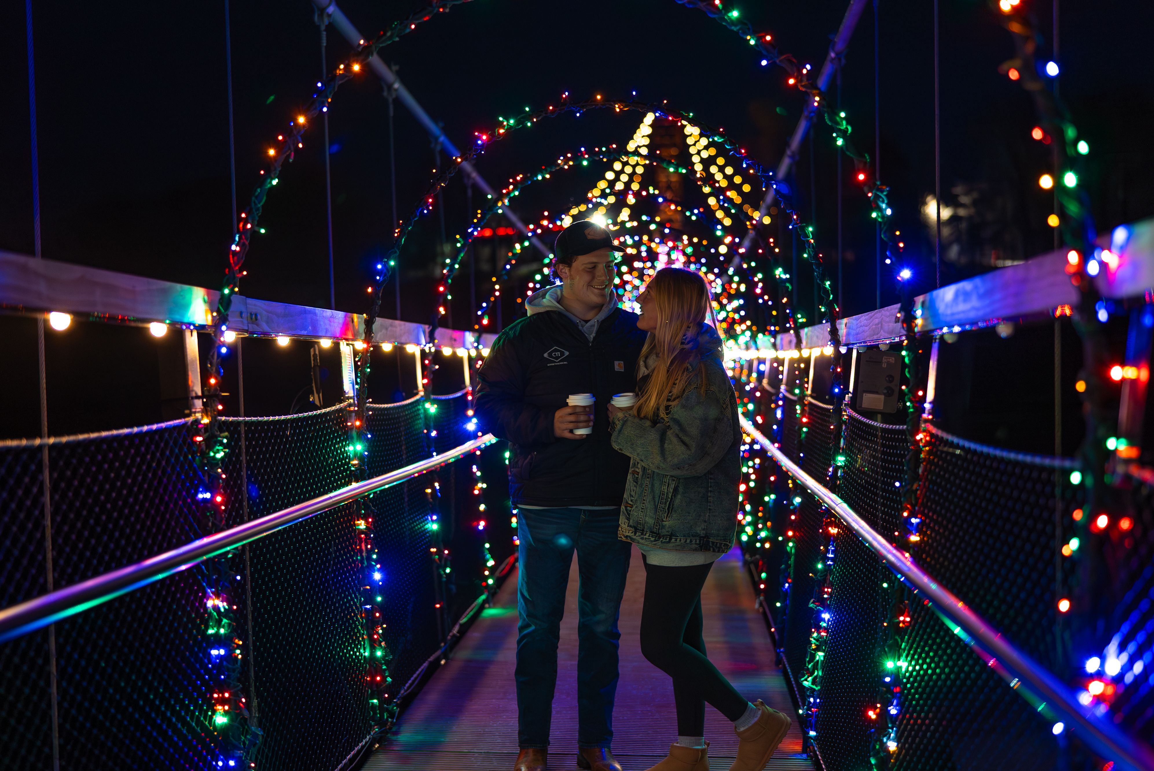Couples standing under lights on SkyBridge Michigan