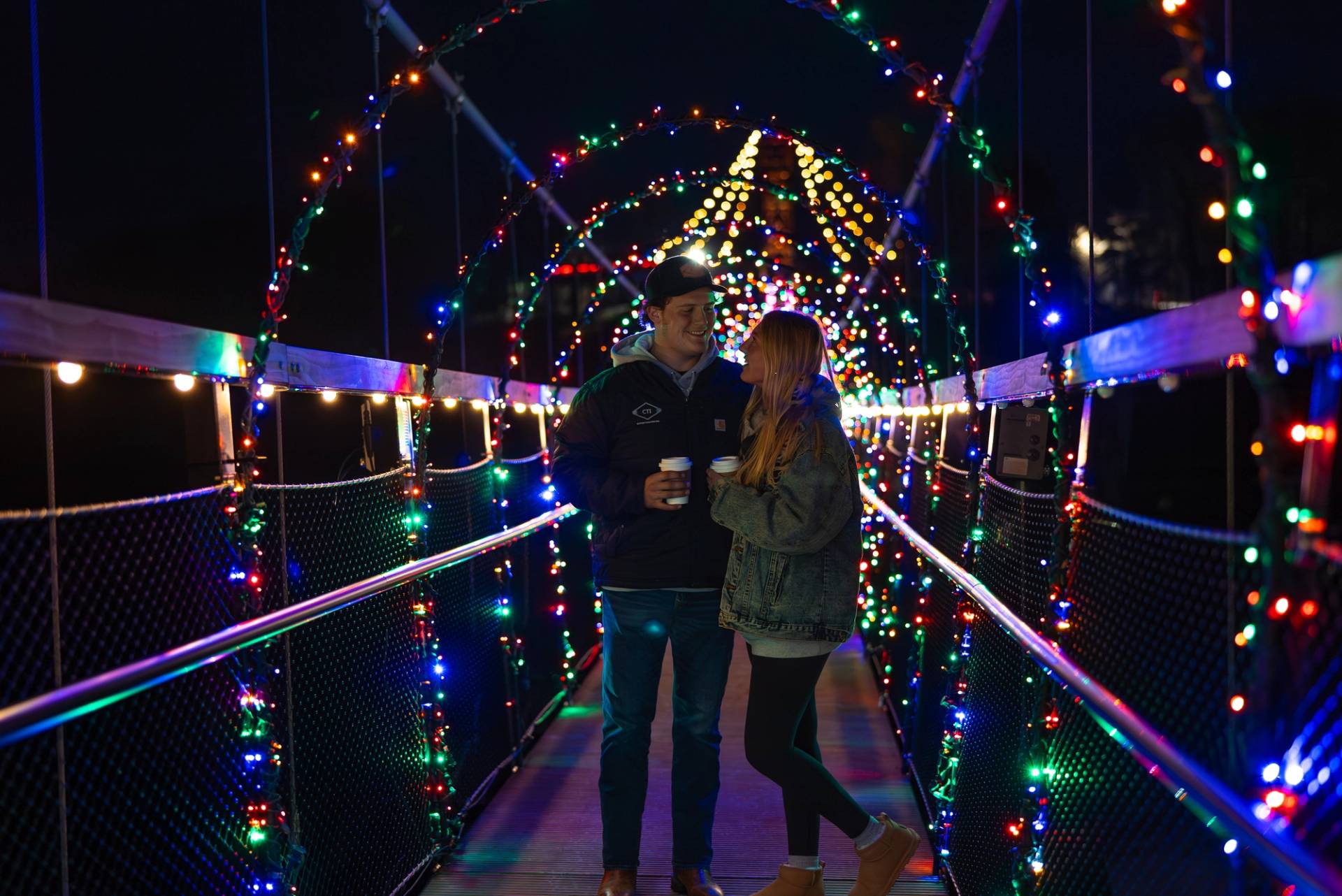 Couples standing under lights on SkyBridge Michigan