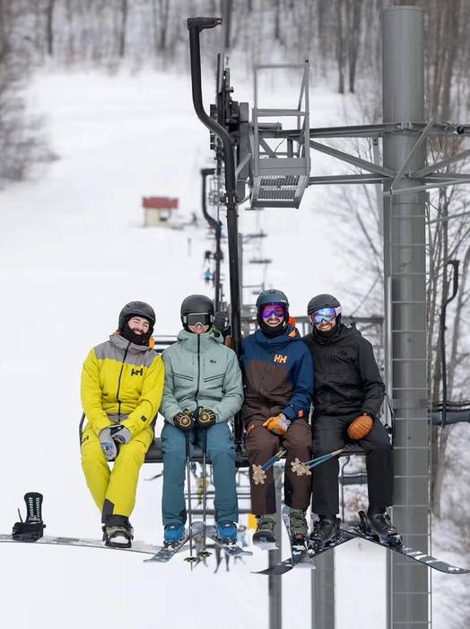 People riding the four place chairlift