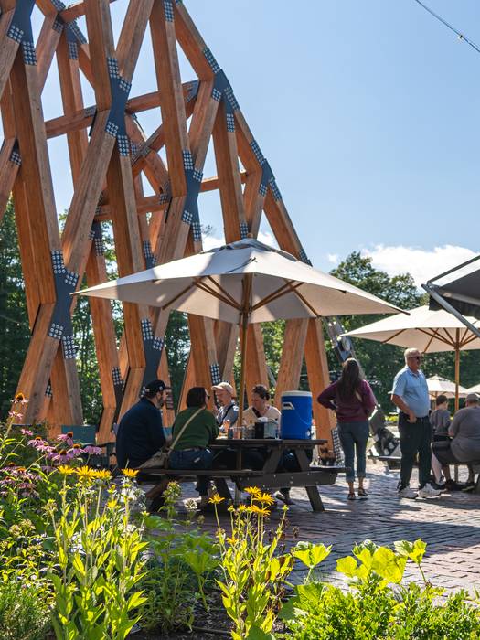 SkyBridge patio with food truck and people eating at picnic tables