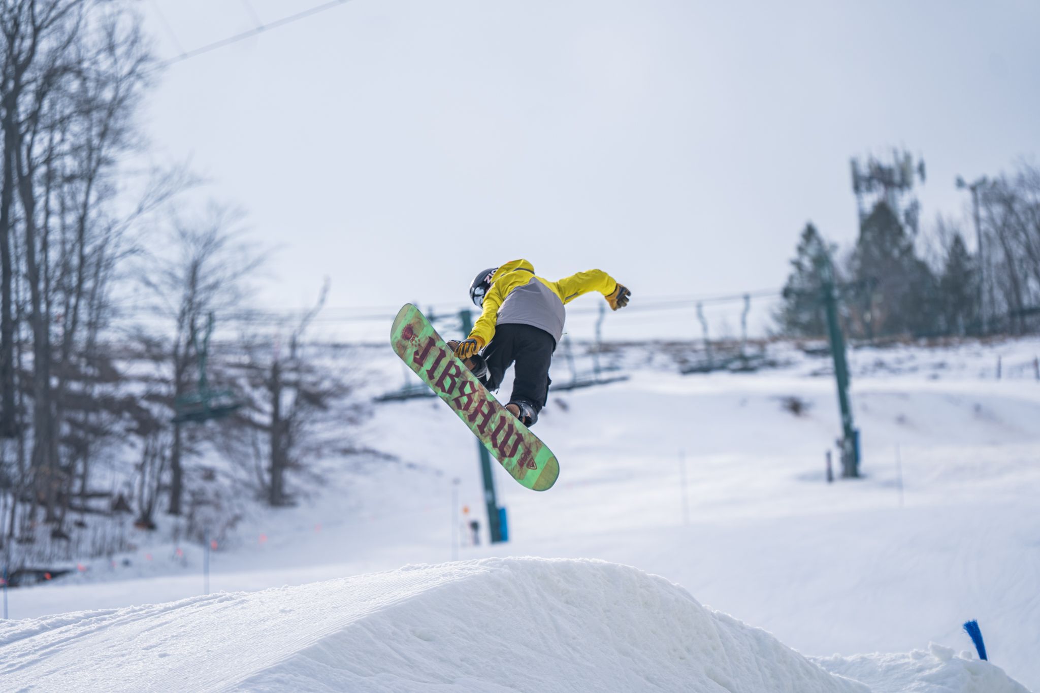 snowboarder grabbing board in terrain park