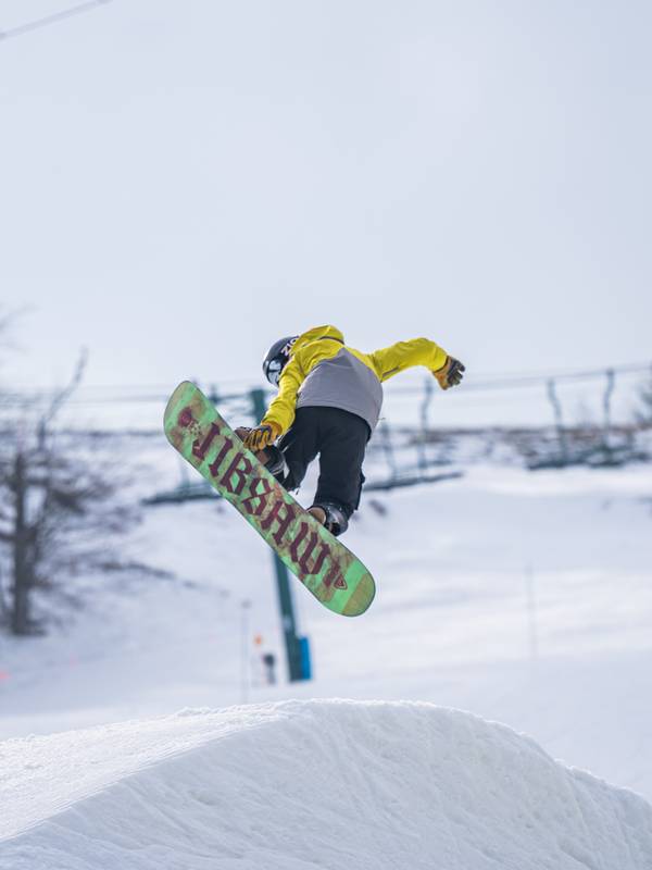 snowboarder grabbing board in terrain park