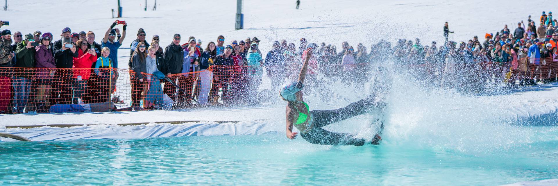 Girl wiping out at the Slush Cup at Boyne Mountain.