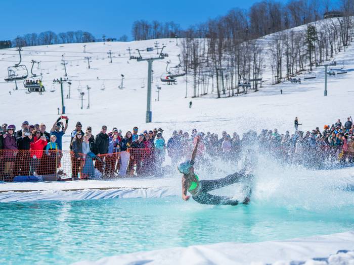 Girl wiping out while riding the slush cup pool