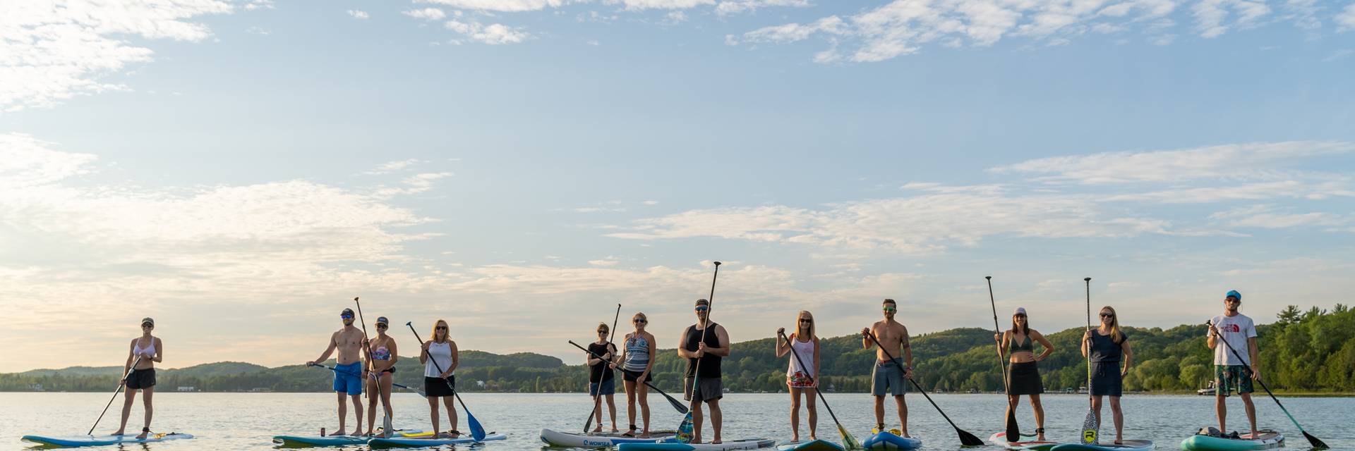guests on paddle boards on deer lake