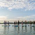 friends paddle boarding on deer lake