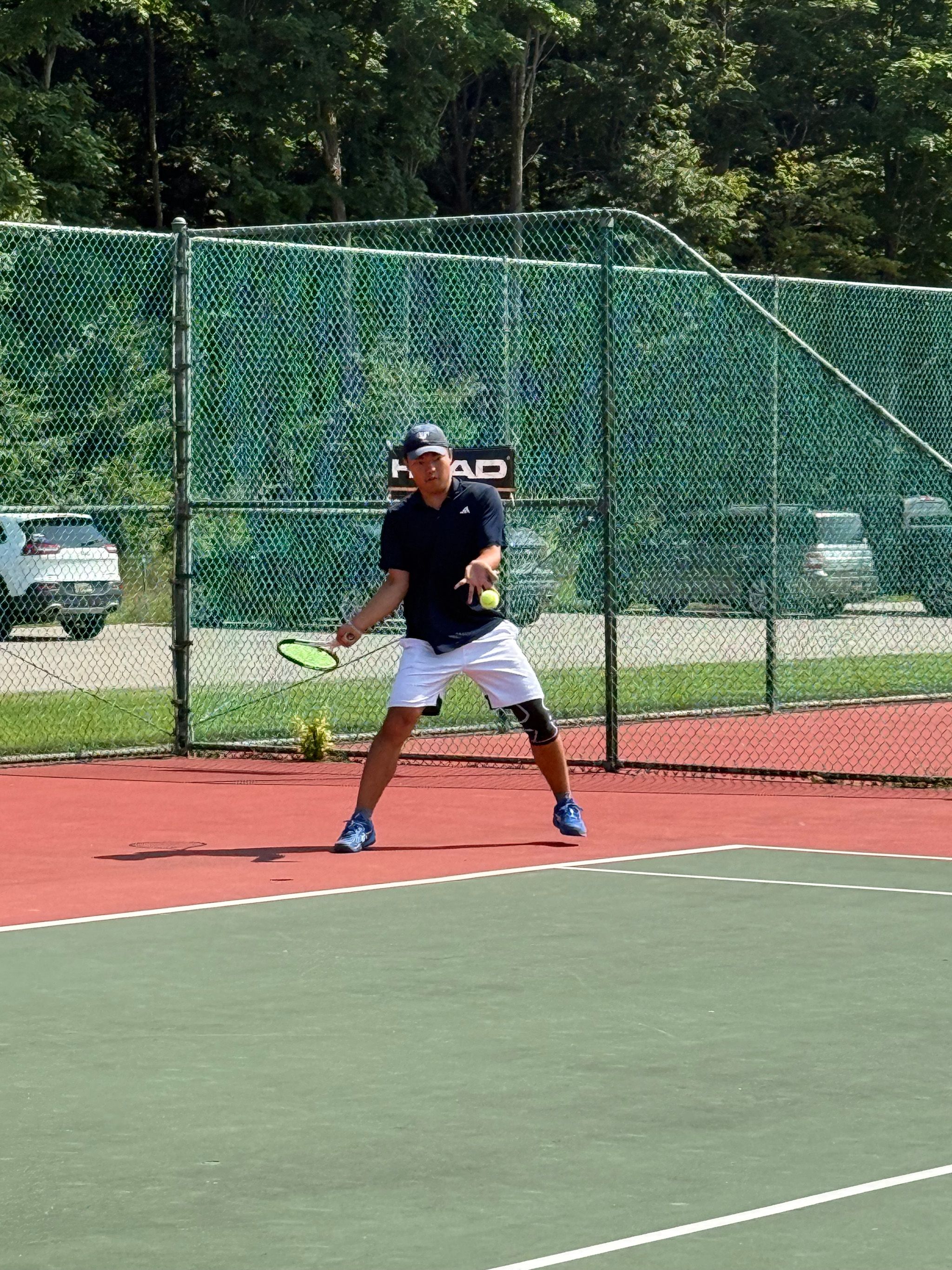 Guy about to hit the tennis ball