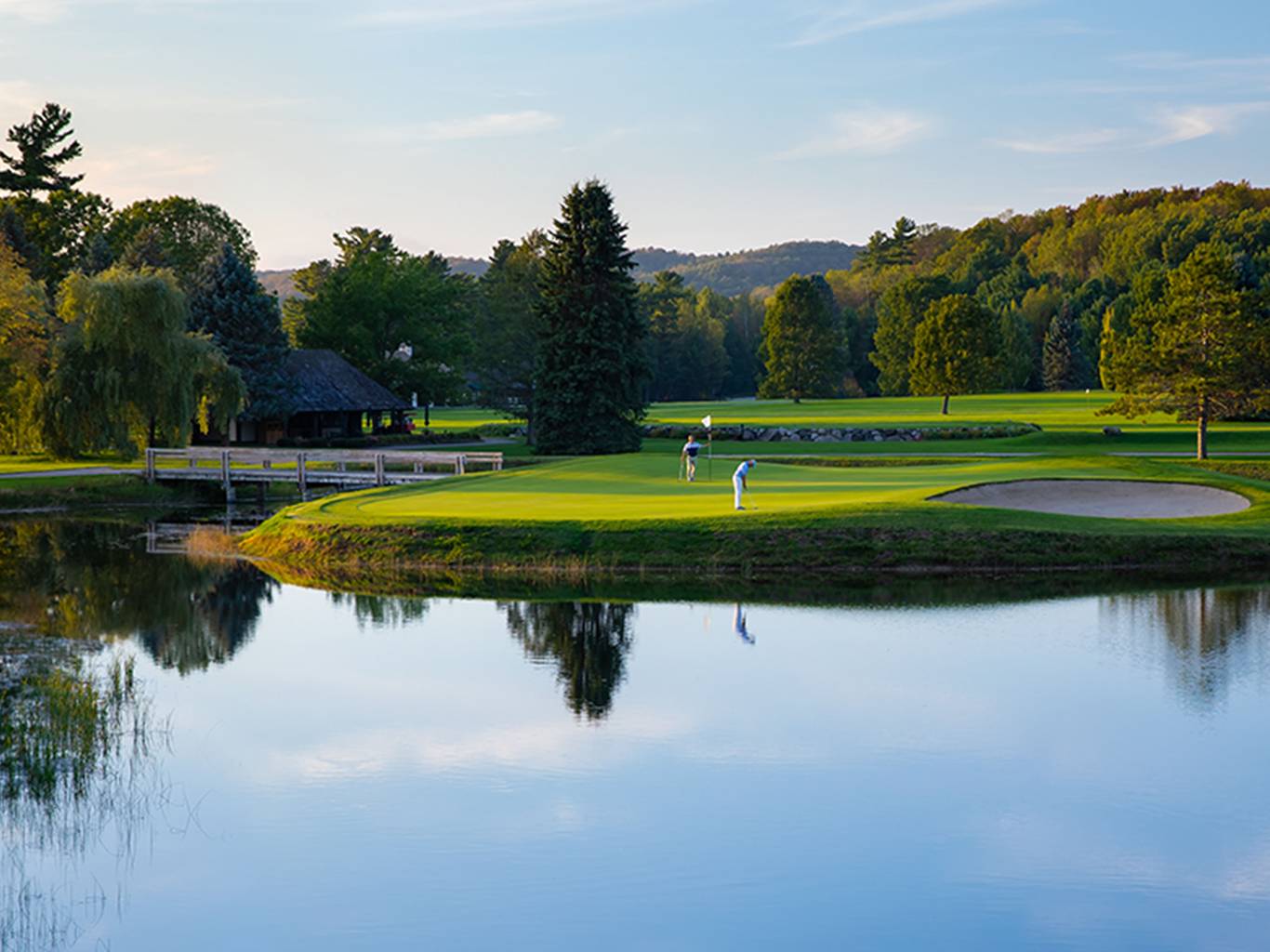 two men putting on the Monument island hole green