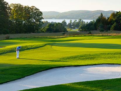 golfer lining up to take a swing