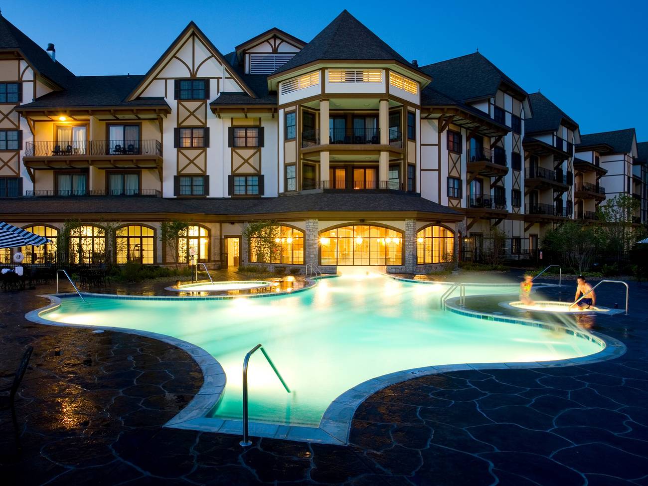 Outside view of the Mountain Grand Lodge pool at night.