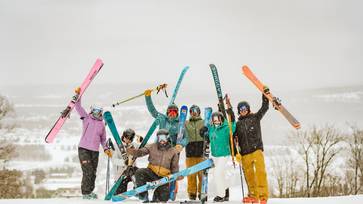 skiers holding skis up