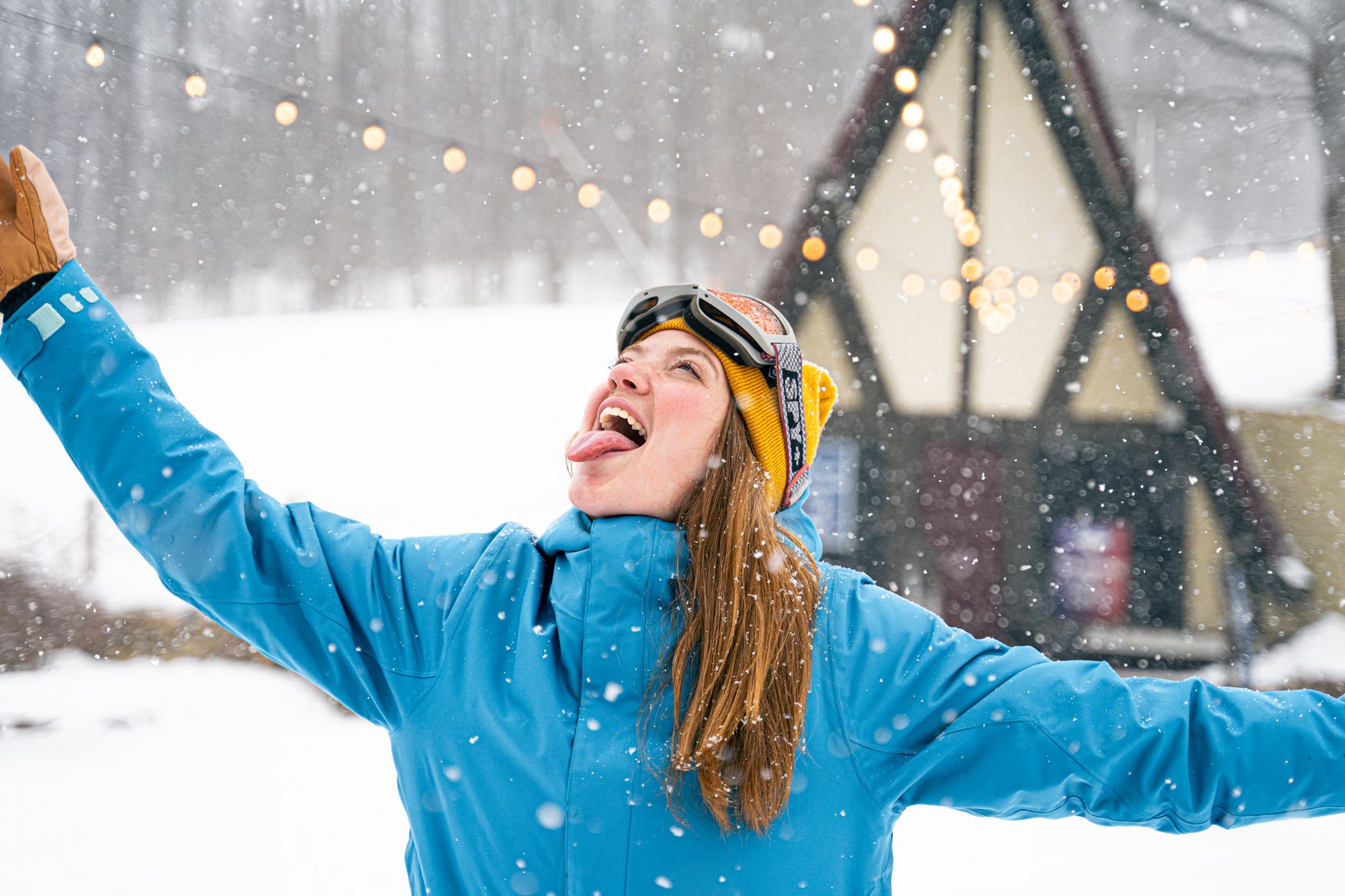girl catching snowflakes outside